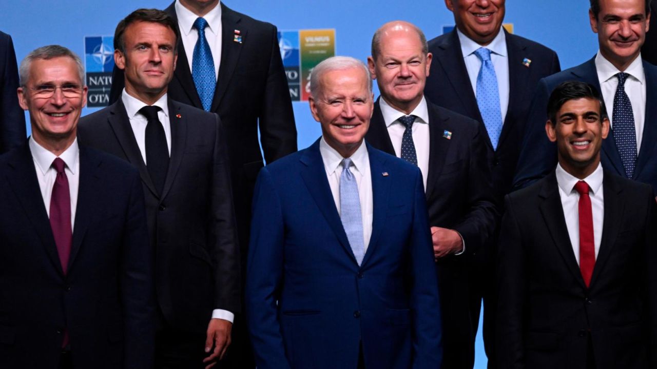 Participants of the NATO Summit including from left front row, NATO Secretary General Jens Stoltenberg, U.S. President Joe Biden, Britain's Prime Minister Rishi Sunak, second row, French President Emmanuel Macron, German Chancellor Olaf Scholz, Greek Prime Minister Kyriakos Mitsotakis, third row, Polish President Andrzej Duda, and Portugal's Prime Minister Antonio Costa pose for an official family photo in Vilnius, Lithuania, Tuesday, July 11, 2023. (Andrew Caballero-Reynolds/Pool Photo via AP)