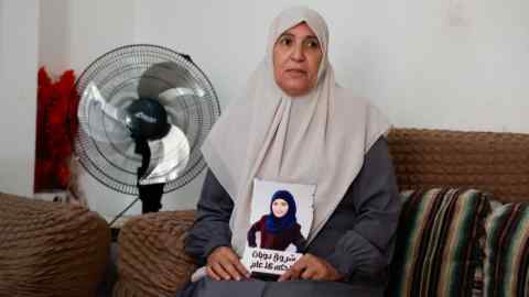 The mother of Shorouq Dwayyat holds a picture of her daughter