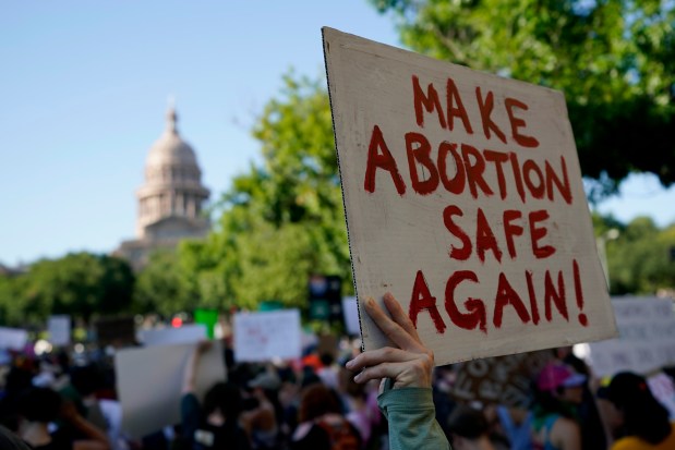 In this file photo, demonstrators march and gather near the state capitol following the Supreme Court's decision to overturn Roe v. Wade on June 24, 2022, in Austin, Texas.