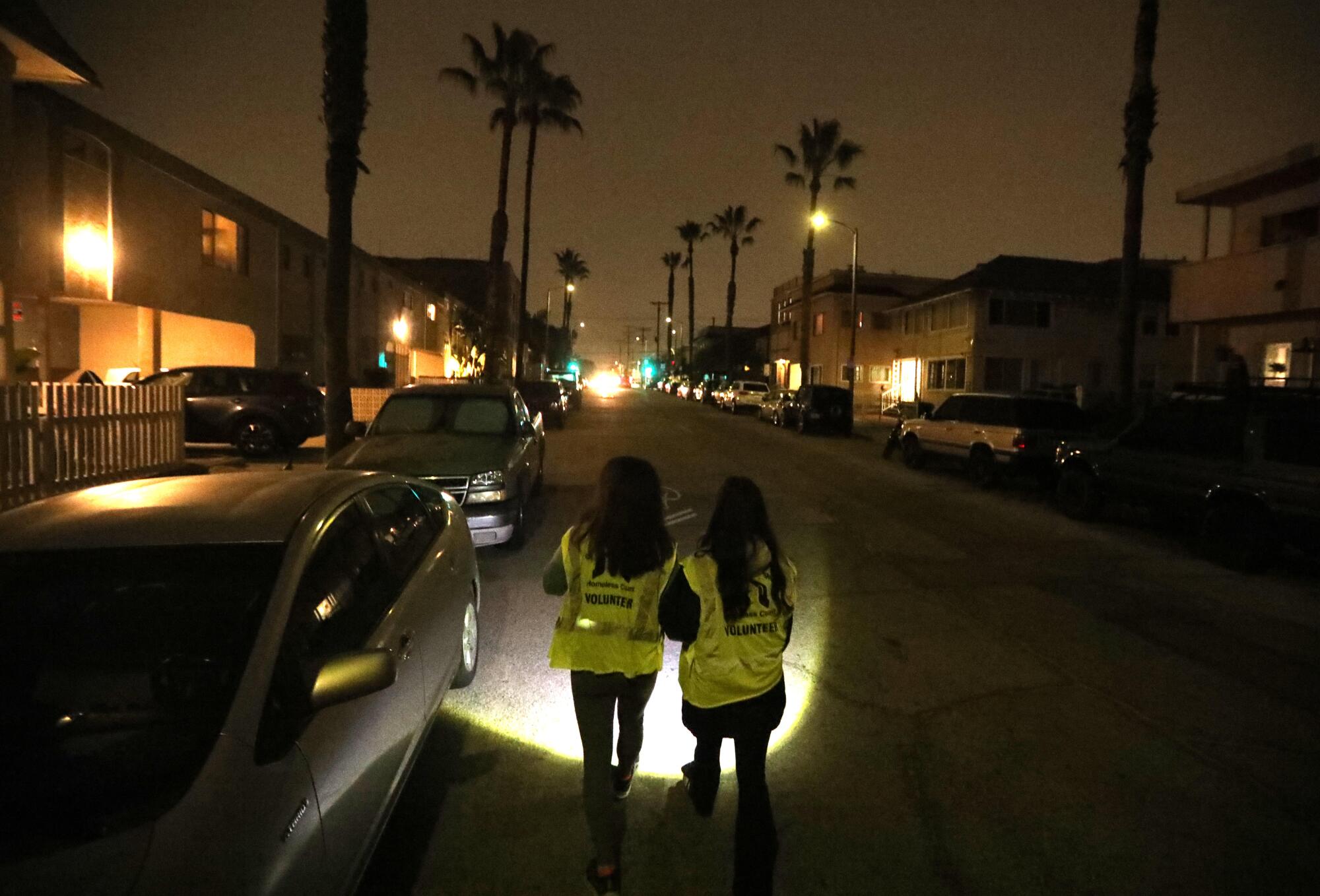 Wah Chen, left, and her daughter, Rainey Renwick, walk down Rose Avenue looking for homeless people in Venice.