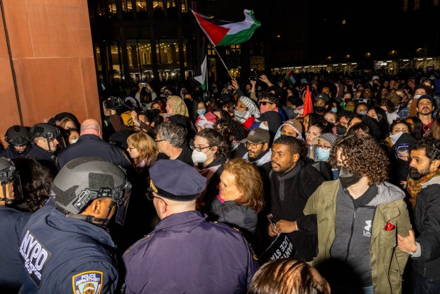 NYPD officers detain pro-Palestinian students and protesters who had set up an encampment on the campus of New York University (NYU) to protest the Israel-Hamas war, in New York on April 22, 2024. (ALEX KENT/AFP via Getty Images)