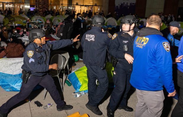 NYPD officers arrive to disperse pro-Palestinian students and protesters who set up an encampment on the campus of New York University (NYU) to protest the Israel-Hamas war, in New York on April 22, 2024. (ALEX KENT/AFP via Getty Images)