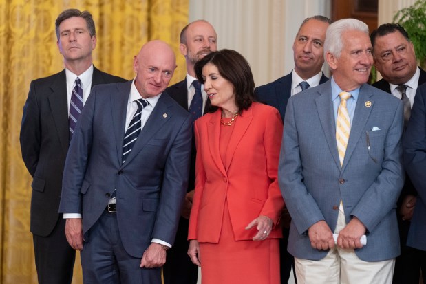 Sen. Mark Kelly, D-Ariz., front left, and New York Governor Kathy Hochul, center, attend an event in the East Room at the White House in Washington, Tuesday, June 4, 2024.